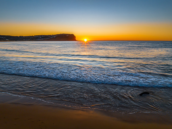 Clear skies and flat surf sunrise seascape