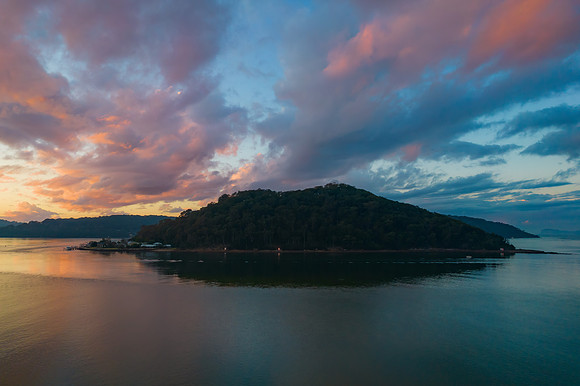 Aerial sunrise waterscape with boats and cloud cover