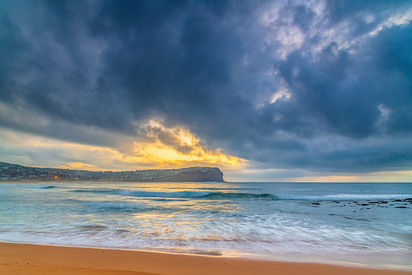 Cloud covered sunrise at the seaside