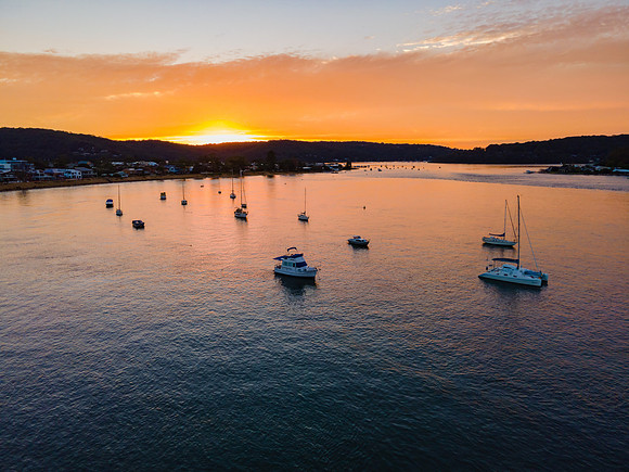 Aerial sunrise waterscape over the channel with orange clouds an