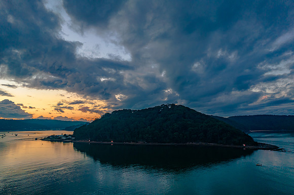 Aerial sunrise waterscape with boats and cloud cover