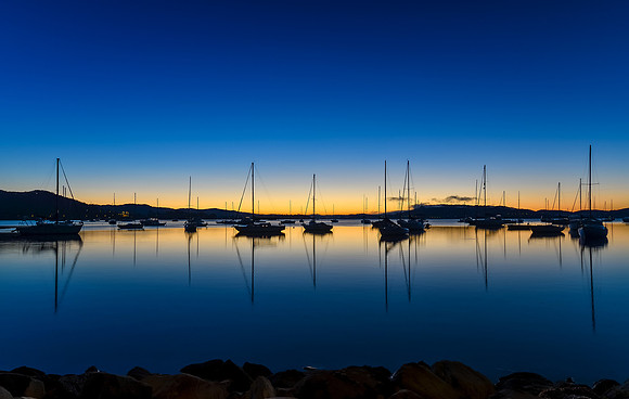 Daybreak waterscape over the bay with boats