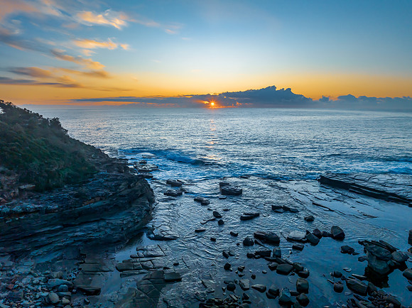 Sunrise over the blue sea and rocky Inlet