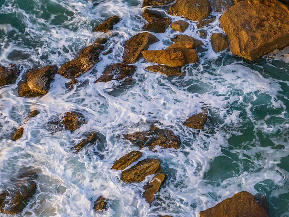 Surf, sea, sand, rocks, sunrise at the beach