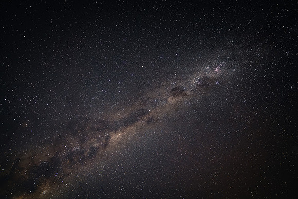 In the dark of the night the stars and milky way sky shine brigh