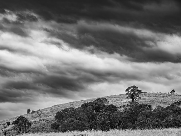 Afternoon storm clouds over the rural countryside in monochrome