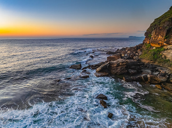 Sunrise seascape with clear skies and orange horizon