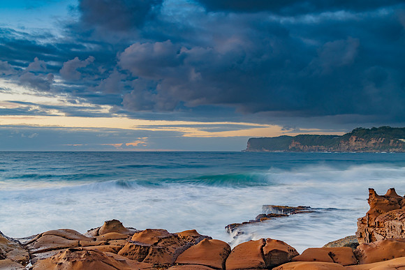 Sunrise, sea, waves, clouds and tessellated rock platform