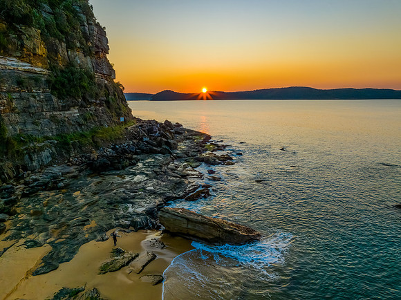 Aerial sunrise over the calm sea and smoke haze clear sky