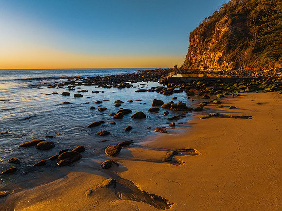 Clear skies and flat surf sunrise seascape