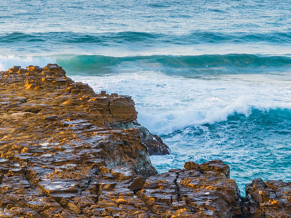 Ocean sunrise with rock platform