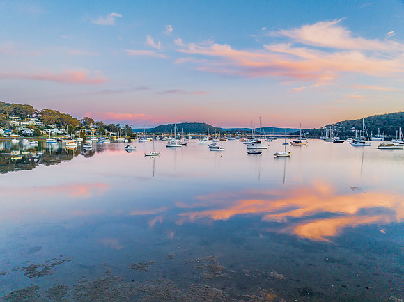 Sunrise blues with boats on the bay