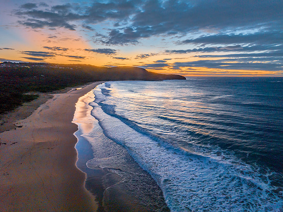 Surf, sea, sand, sunrise with clouds