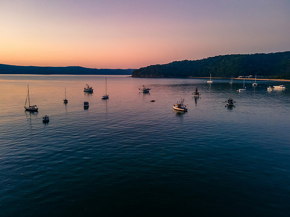Boats at rest and gentle sunrise over the bay