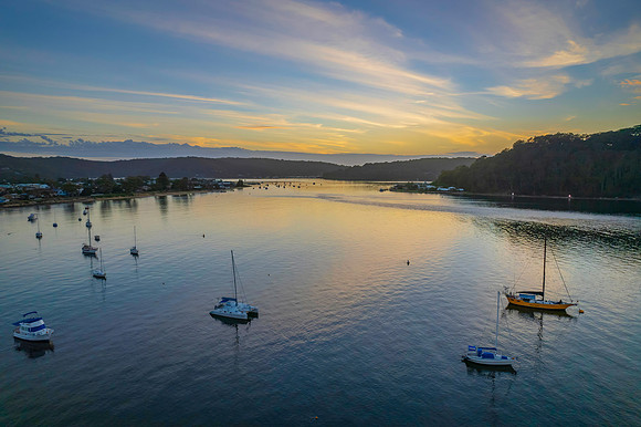 Aerial sunrise waterscape with boats