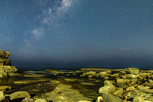 The night sky and the Milky Way with rocky inlet