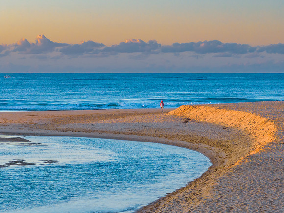 Summer sunrise at the seaside with clouds and haze