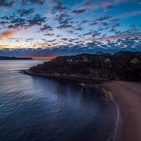 Aerial sunrise seascape with pretty cloud filled sky