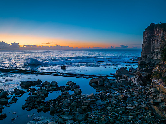 Sunrise over the blue sea and rocky Inlet