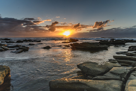 Cloudy and Rocky Sunrise Seascape