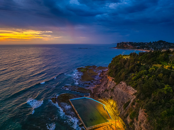 Pretty Sunrise at the seaside with rain clouds