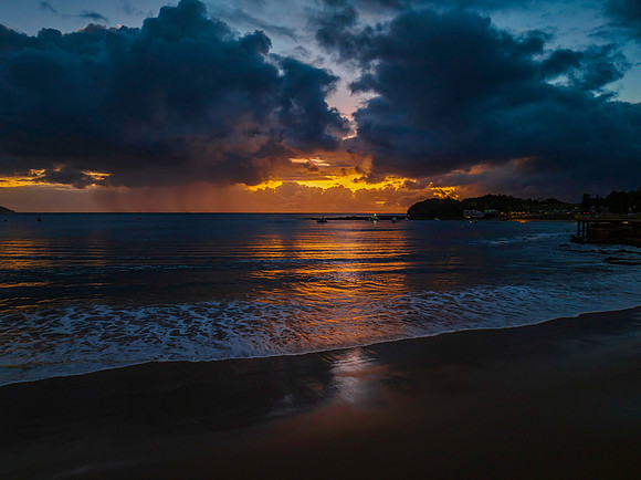 Aerial sunrise at the seaside with rain clouds