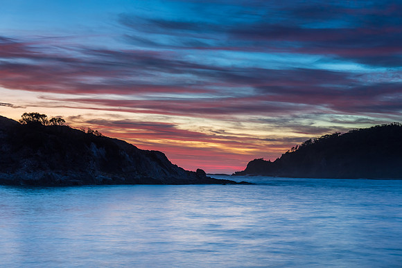 Colourful High Cloud Sunrise Seascape and Rock Formations