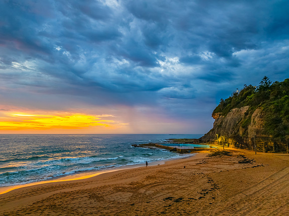 Pretty Sunrise at the seaside with rain clouds