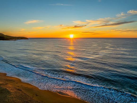 Sunrise at the seaside with high cloud
