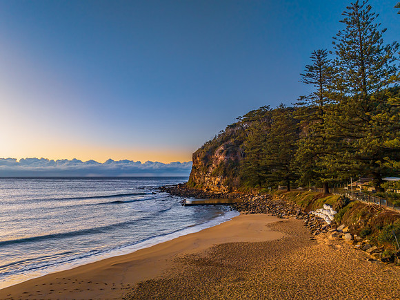 Sunrise at the seaside with low cloud bank and sea pool
