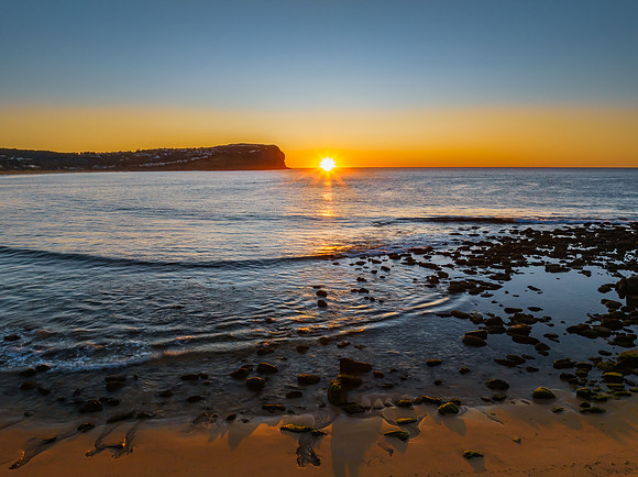 Clear skies and flat surf sunrise seascape