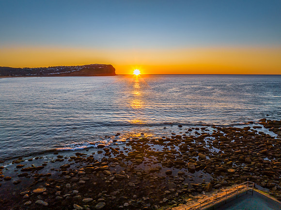 Clear skies and flat surf sunrise seascape