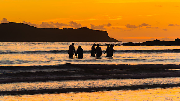 Sunrise Seascape with People Silhouettes