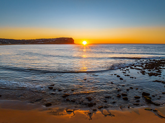 Clear skies and flat surf sunrise seascape