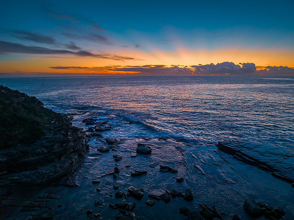 Sunrise over the blue sea and rocky Inlet