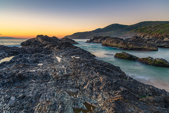 Sunrise seascape and a rocky beach