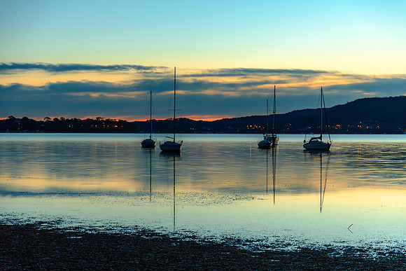 Daybreak waterscape over the bay with boats