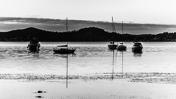 Daybreak waterscape  with boats in black and white