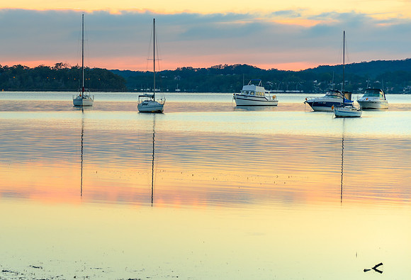 Daybreak waterscape over the bay with boats