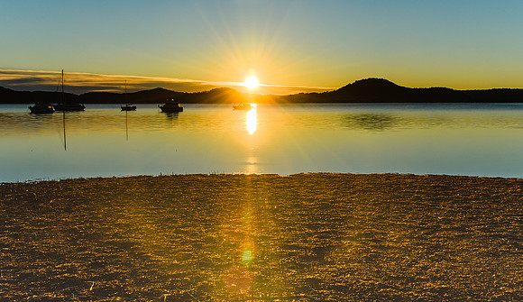 Daybreak waterscape over the bay with boats