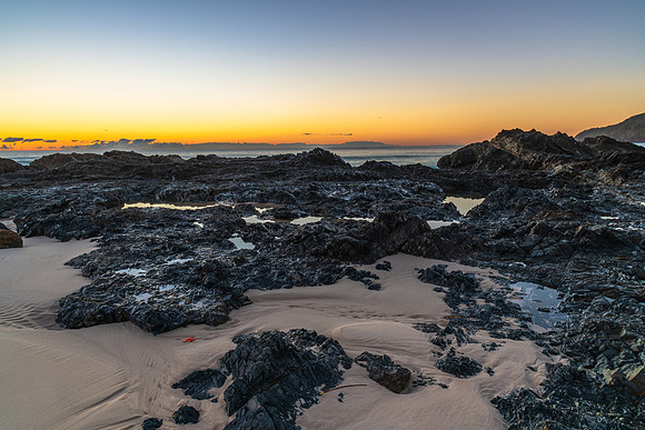Sunrise seascape and a rocky beach
