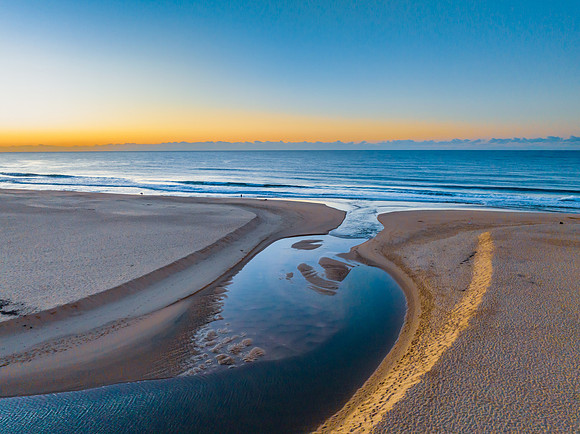 Summer sunrise at the seaside with clouds and haze
