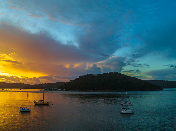 Aerial sunrise waterscape with boats, colour and clouds