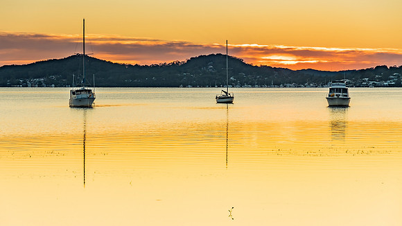 Daybreak waterscape over the bay with boats