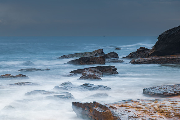 Sunrise at the seaside with rocks and beautiful diffused light b