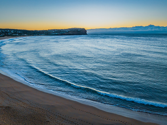 Sunrise over the ocean with low cloud bank