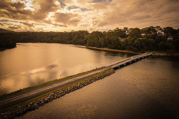 A winters day view over the lake with road and bridge