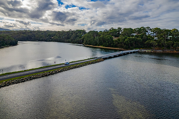 A winters day view over the lake with road and bridge