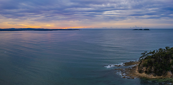 Cloud covered aerial sunrise seascape over the cove