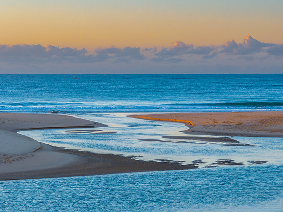 Summer sunrise at the seaside with clouds and haze